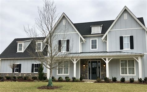 grey house with silver metal roof|black roof with gray siding.